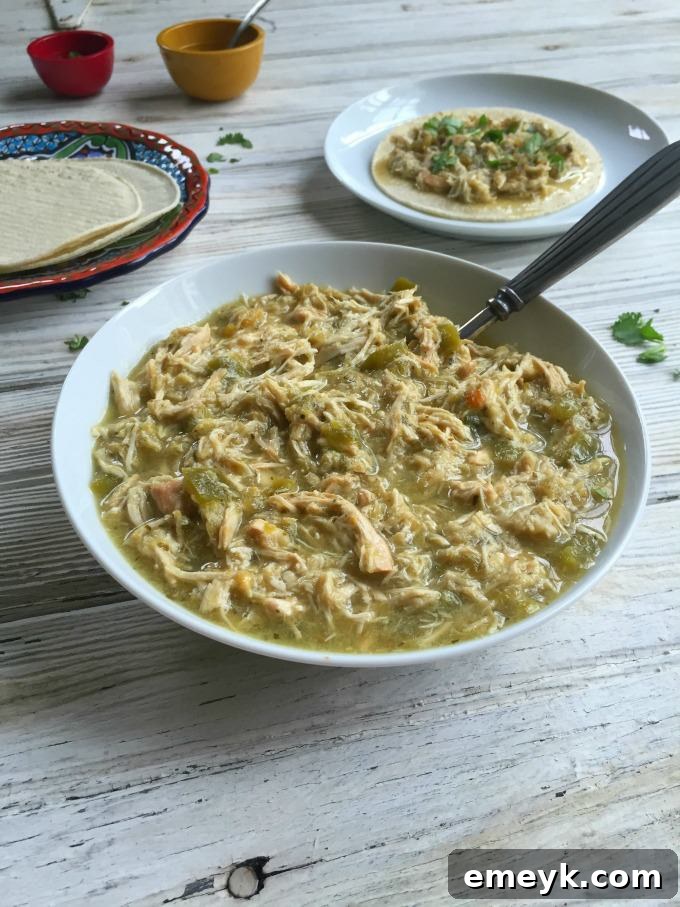 Simmered Salsa Verde Chicken Tacos 8 Slow Cooker Salsa Verde Chicken Tacos served in soft tortillas with toppings