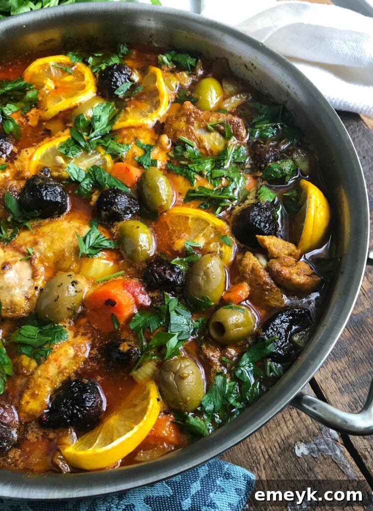 Large pan of Moroccan Chicken Thighs with garnishes