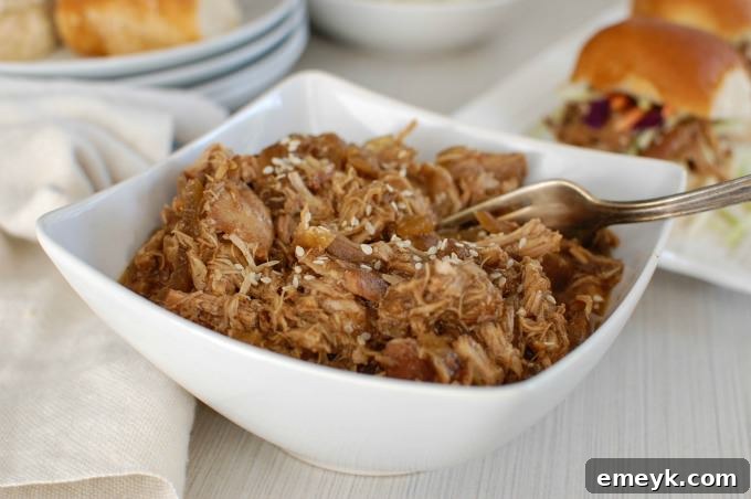 An array of Slow Cooker Asian Honey Sesame Chicken Sliders laid out on a platter, perfect for a game day spread.