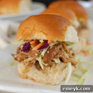 Slow Cooker Asian Honey Sesame Chicken Sliders, served on a platter.