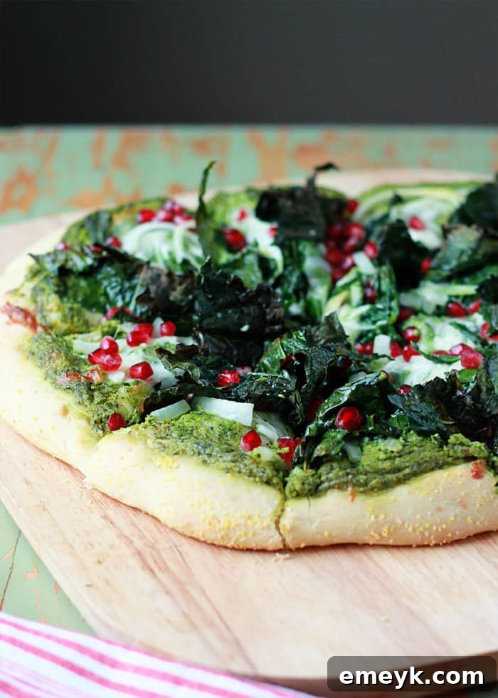 Gourmet Kale & Pomegranate Pizza with creamy pesto sauce.
