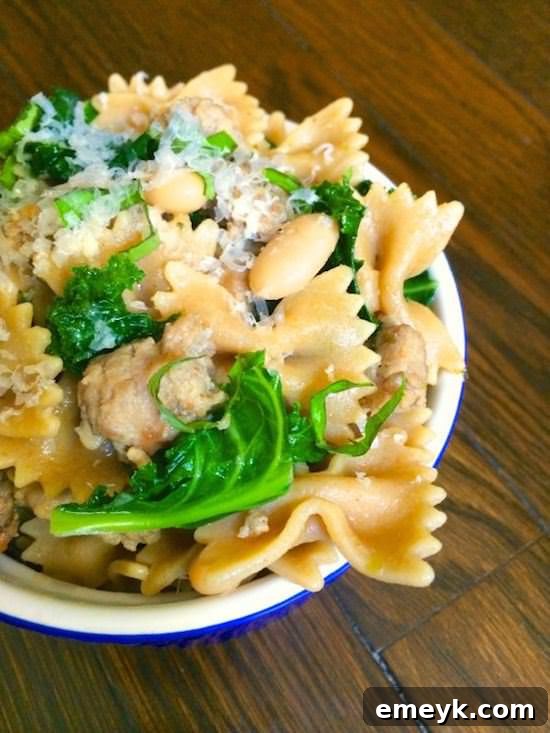 Wholesome Bowtie Pasta with sausage, white beans, and fresh kale.