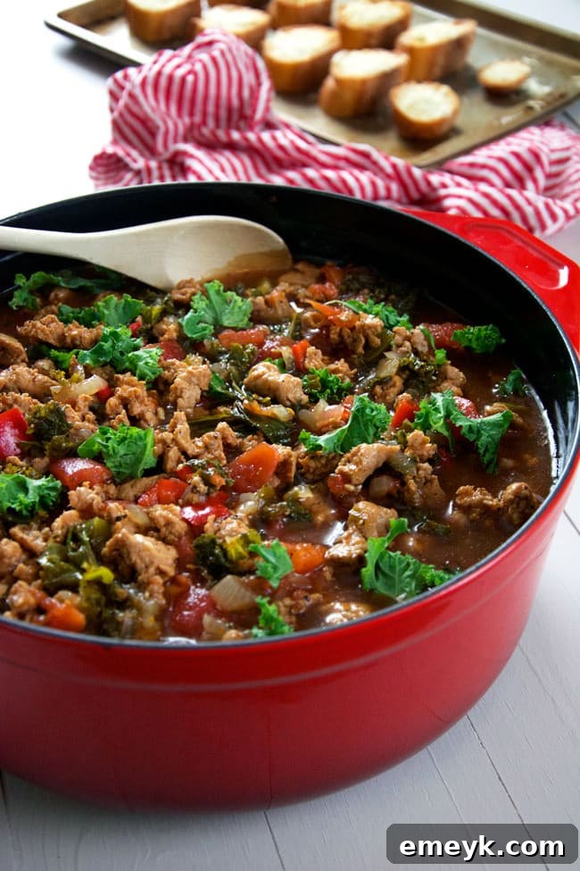 Comforting Sweet Italian Sausage Soup with fresh kale and cheesy croutons.