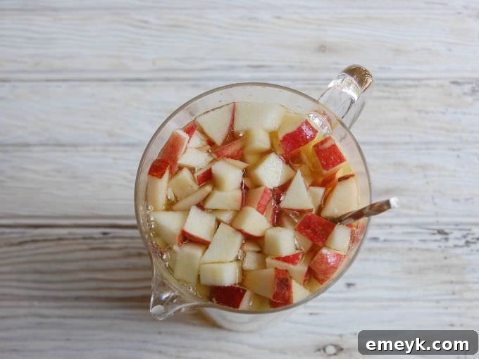 Ingredients for Sparkling Apple Pear Sangria laid out on a rustic wooden surface.