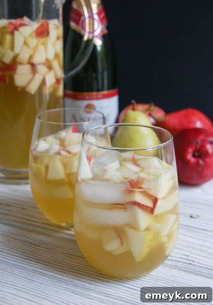 A beautifully set table with glasses of Sparkling Apple Pear Sangria, ready for guests.