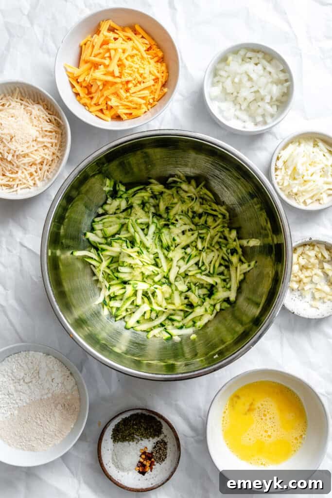 Grated zucchini in a bowl after being squeezed of excess liquid, ready for mixing.
