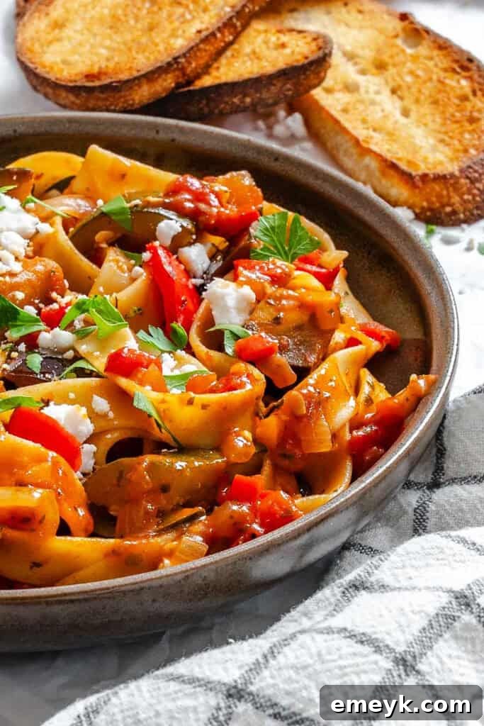 Delicious Ratatouille Pappardelle served in a rustic bowl, garnished with fresh herbs and feta.