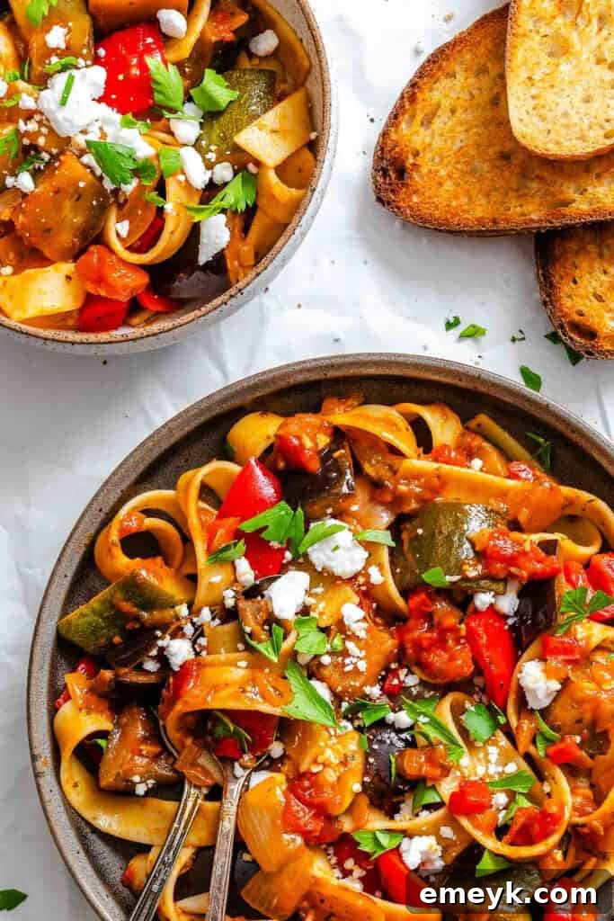 A beautifully presented bowl of Ratatouille Pappardelle with fresh garnishes.