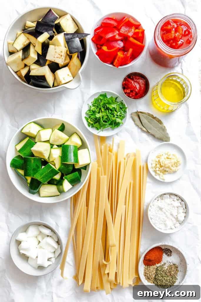 Fresh ingredients laid out for Ratatouille Pappardelle including vegetables, herbs, and pasta.