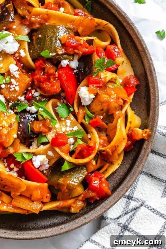 Close-up of Ratatouille Pappardelle with a generous topping of feta cheese and parsley.