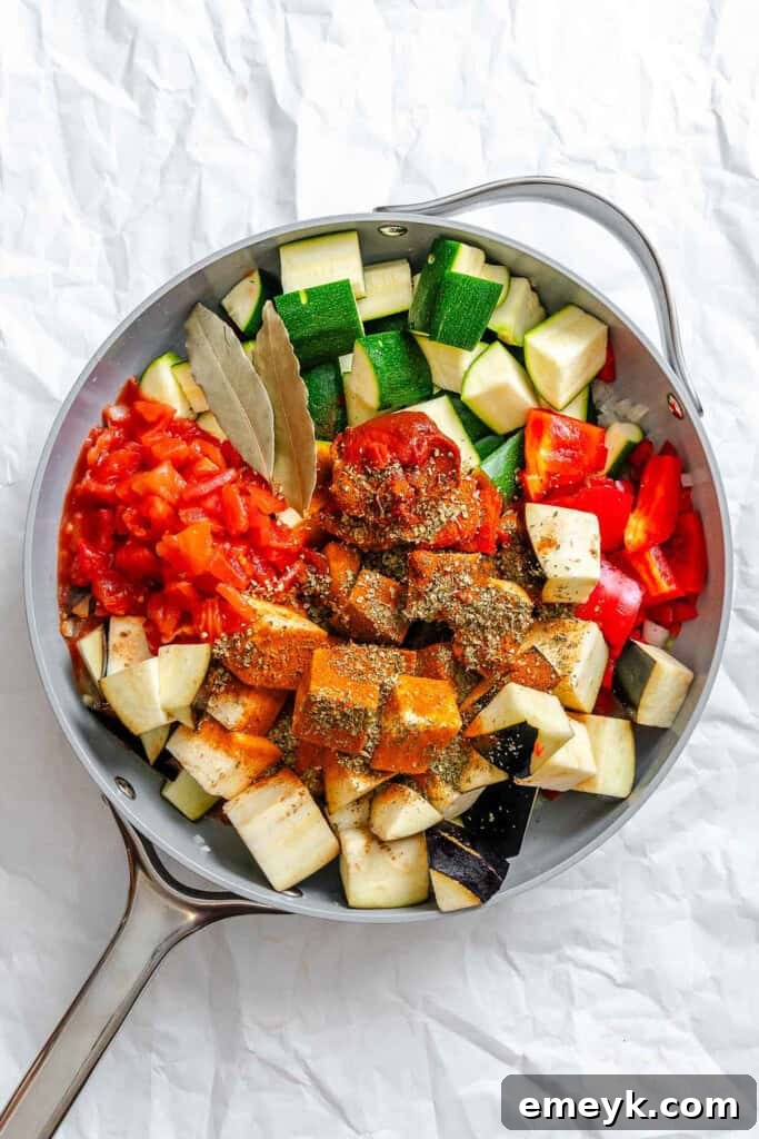 Vegetables and spices simmering together in a large pan for Ratatouille Pappardelle.