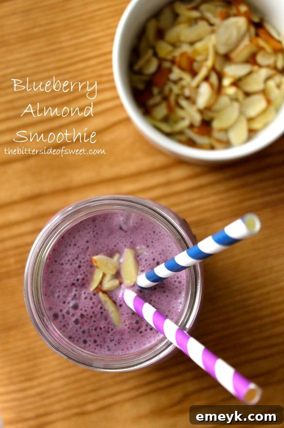 Creamy Blueberry Almond Smoothie in a tall glass with a straw