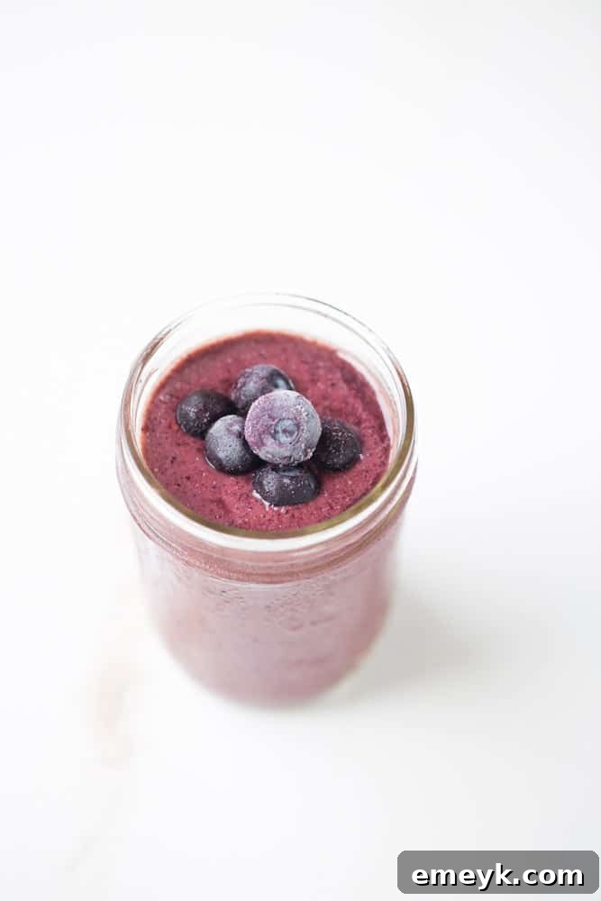 Bright Berry Cherry Pineapple Smoothie in a clear glass