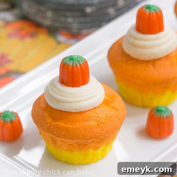 Autumn Ombre Cupcakes 2 Vibrant Candy Corn Cupcakes arranged artfully for Halloween celebrations