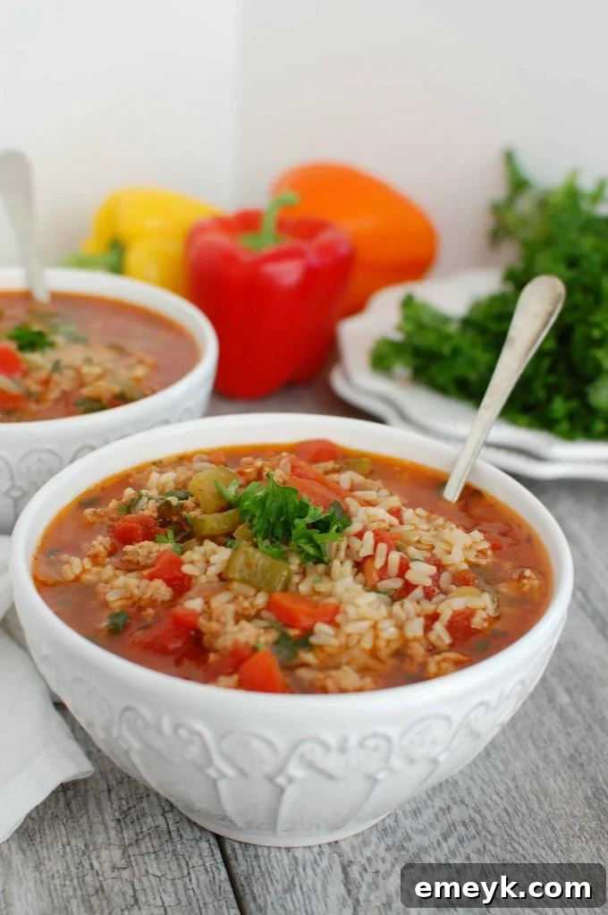 Delicious Slow Cooker Stuffed Pepper Soup served in a bowl, garnished with fresh parsley.