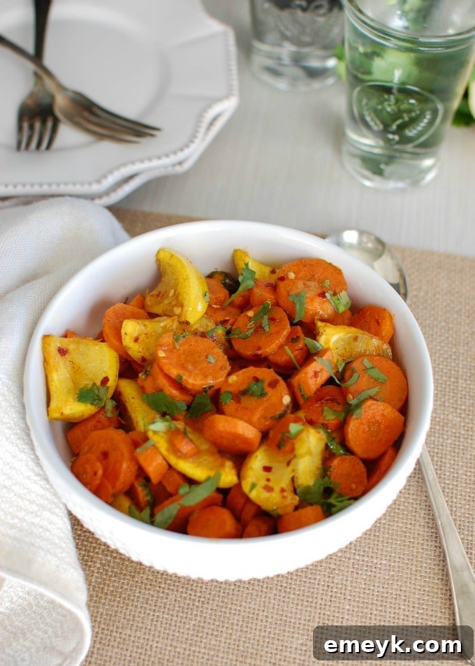 Close-up view of perfectly roasted Moroccan carrots with visible spices, lemon zest, and fresh cilantro