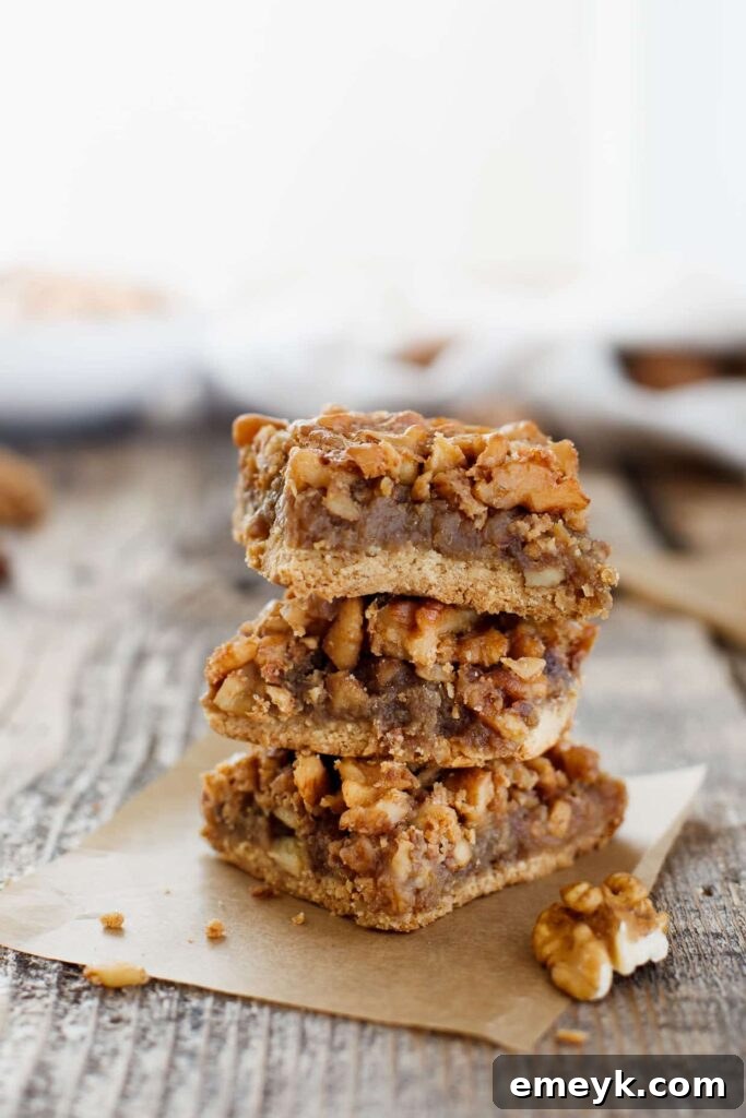 Irresistible Thanksgiving Treats 11 Golden-brown maple walnut bars with a crumbly topping, some showing a gooey center.