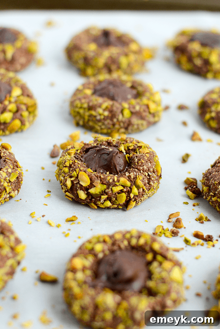 Irresistible Thanksgiving Treats 16 Assortment of healthy thumbprint cookies with various fillings like chocolate and pistachio, on a platter.