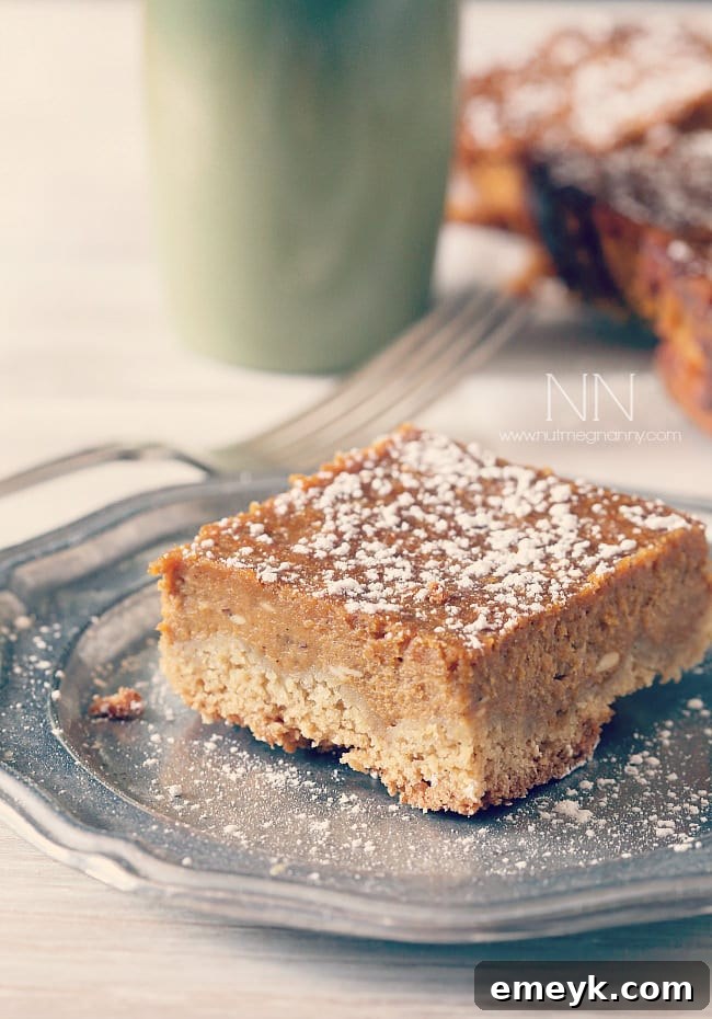 Irresistible Thanksgiving Treats 17 Pumpkin pie cake bars with a crumble topping, sliced into neat squares on a cooling rack.