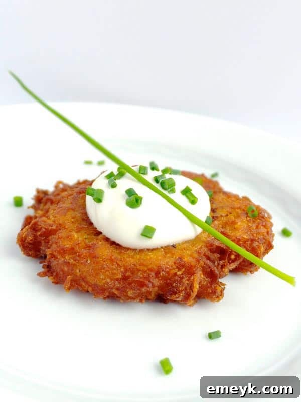 Crispy Potato Latkes served with a dollop of creamy horseradish sauce