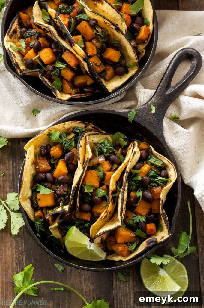 Delicious Butternut Squash, Black Bean and Kale Tacos on a wooden board