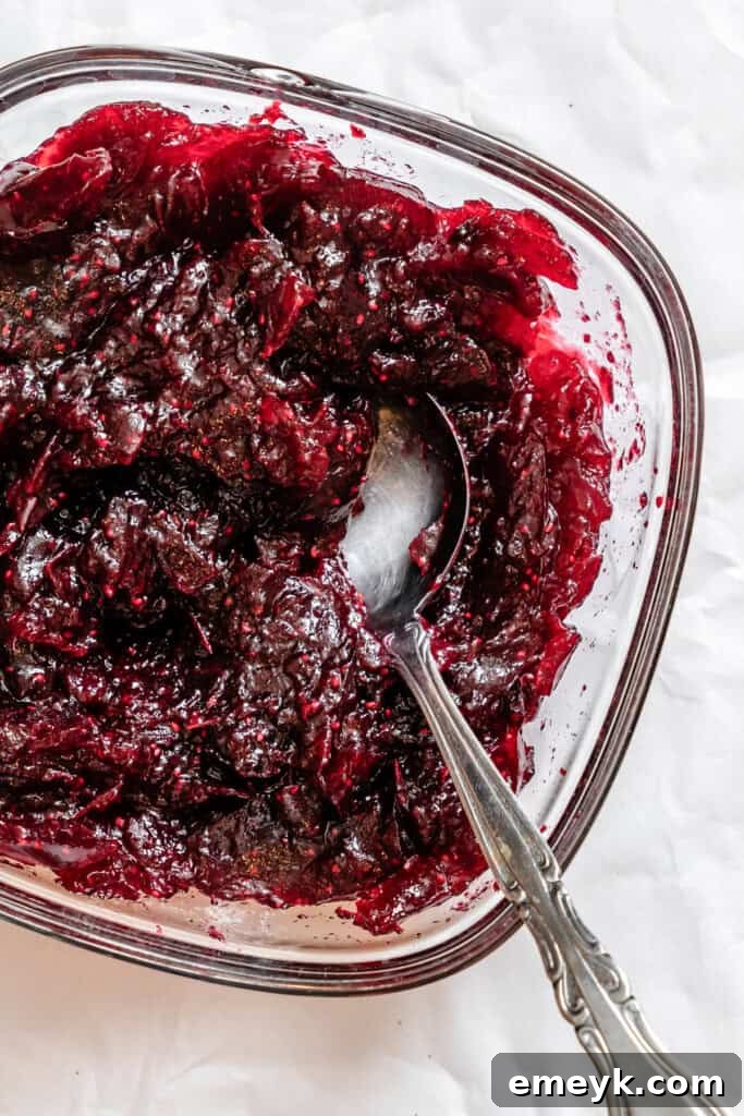 Cooked cranberry orange sauce cooling in a bowl
