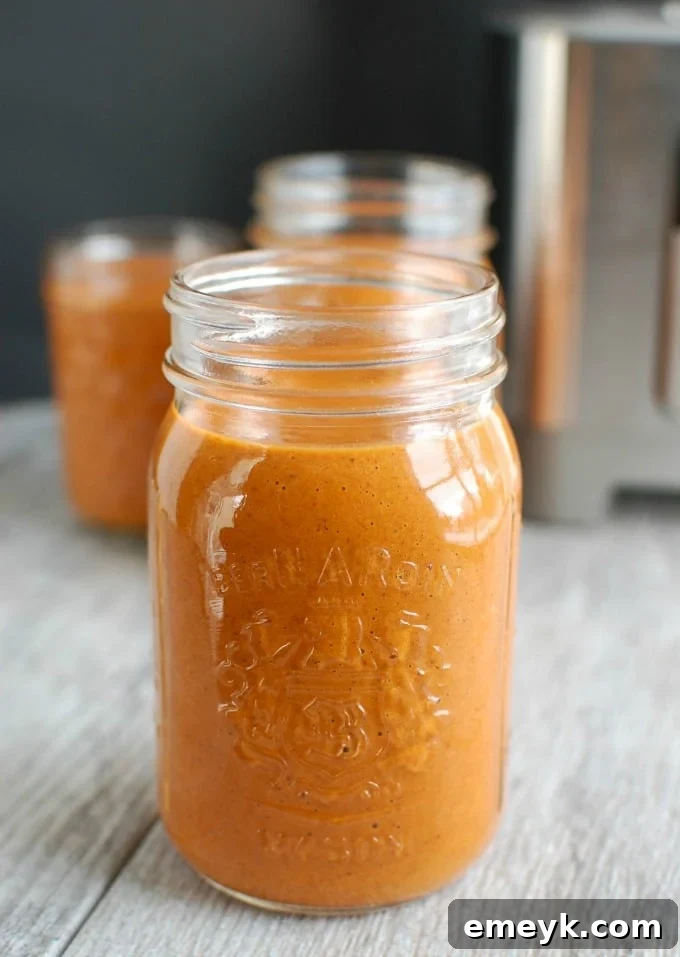 Homemade Enchilada Sauce in a glass jar, showcasing its rich, vibrant red color, ready to be used in various dishes.