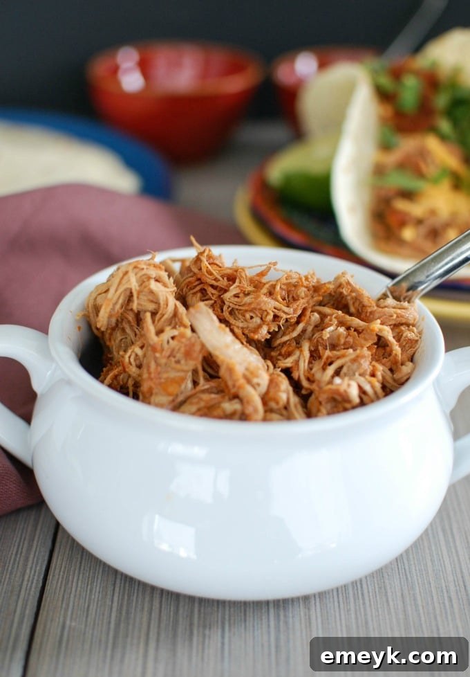 Fall-Apart Slow Cooker Pork Tacos 3 Slow Cooker Shredded Pork Tacos - A vibrant overhead shot of a single taco bursting with tender pork and fresh toppings.