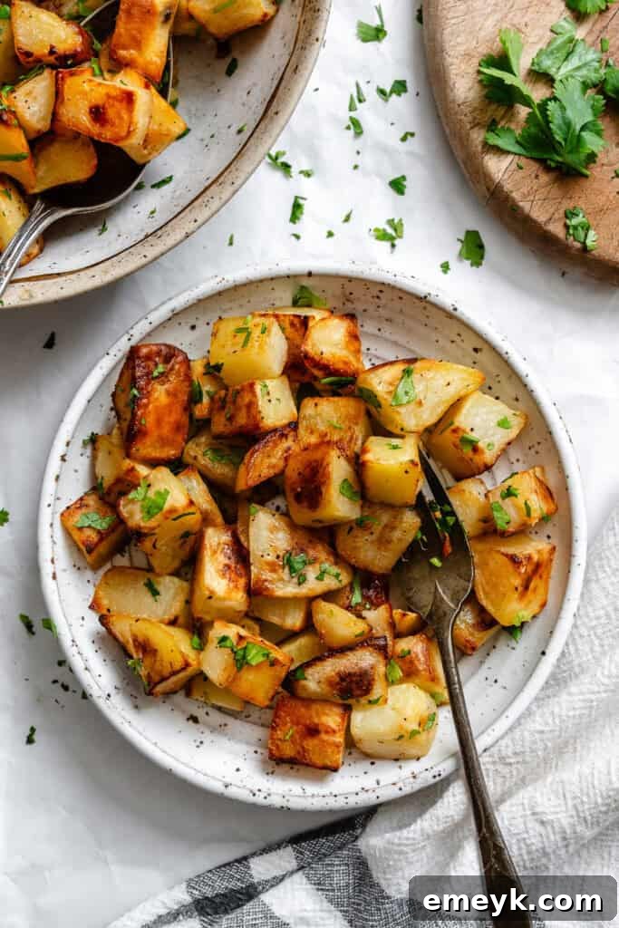 Lemon Cilantro Roasted Potatoes in a bowl with spoon