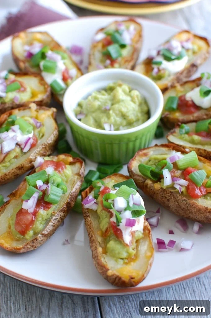Zesty Guacamole-Filled Potato Shells 3 Guacamole Stuffed Potato Skins on white plate