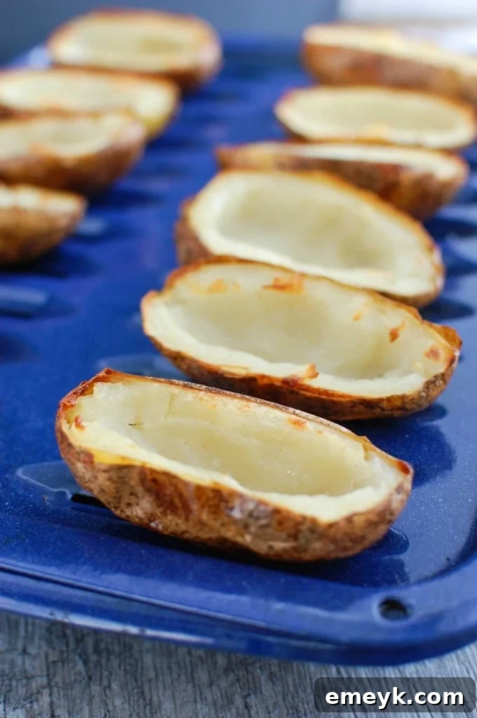 Zesty Guacamole-Filled Potato Shells 6 Guacamole Stuffed Potato Skins on a baking sheet
