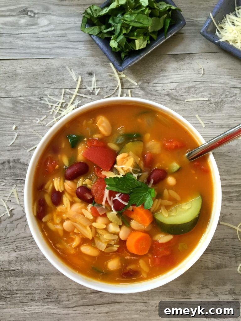 A warm bowl of 30 Minute Orzo Minestrone Soup, with colorful vegetables and orzo pasta