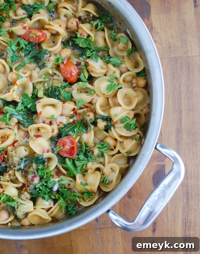A vibrant One Pot Chickpea Kale Pasta Recipe in a large skillet, ready to serve.