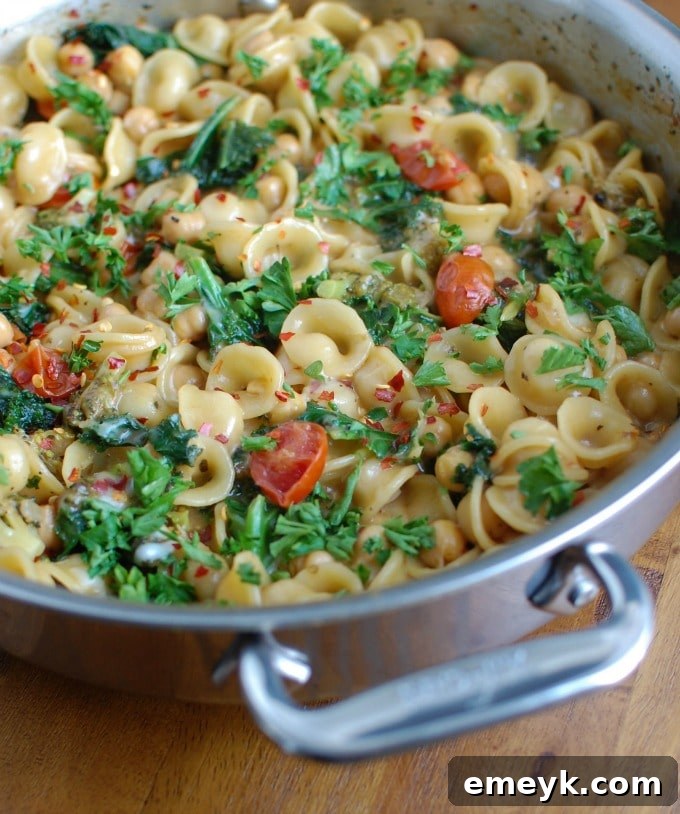Close-up of One Pot Chickpea Kale Pasta garnished with fresh parsley.