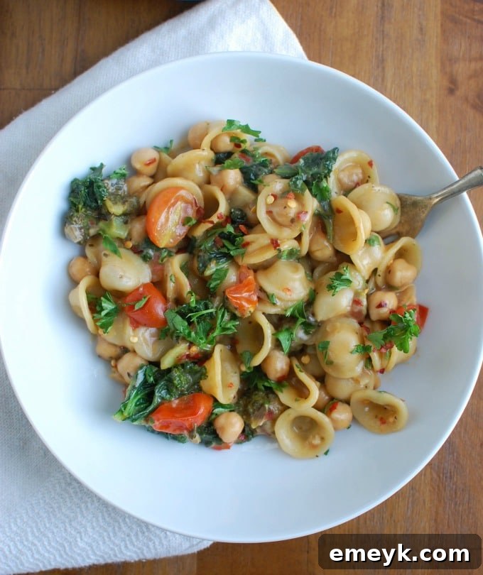One Pot Chickpea Kale Pasta Recipe served in a bowl, showcasing fresh ingredients.