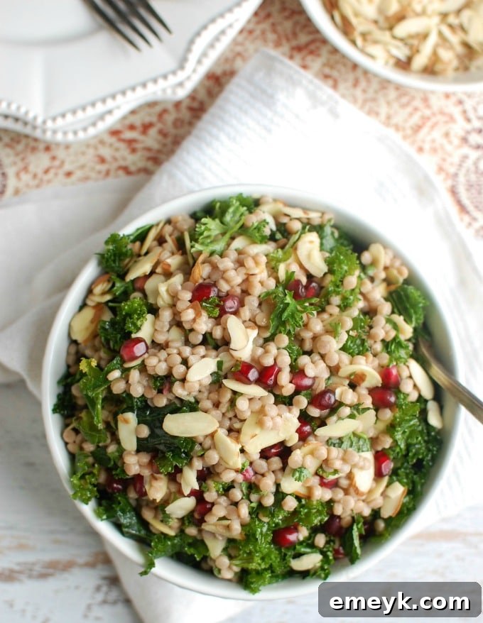 Close-up of Kale Couscous Pomegranate Salad showcasing fresh mint and pomegranate arils