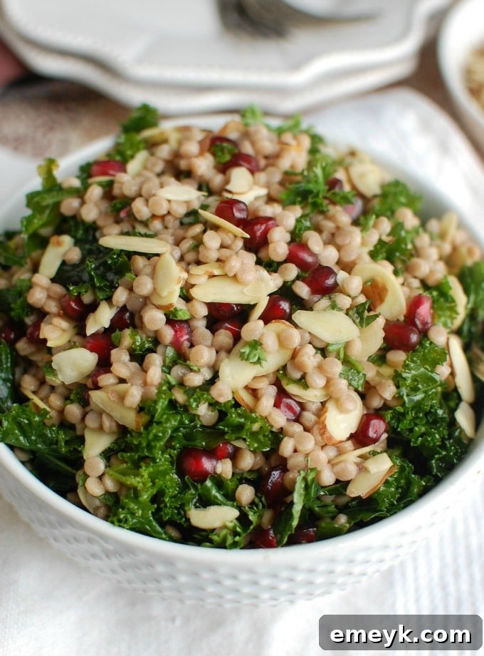 A bowl of Kale Couscous Pomegranate Salad, highlighting its health benefits for lunch