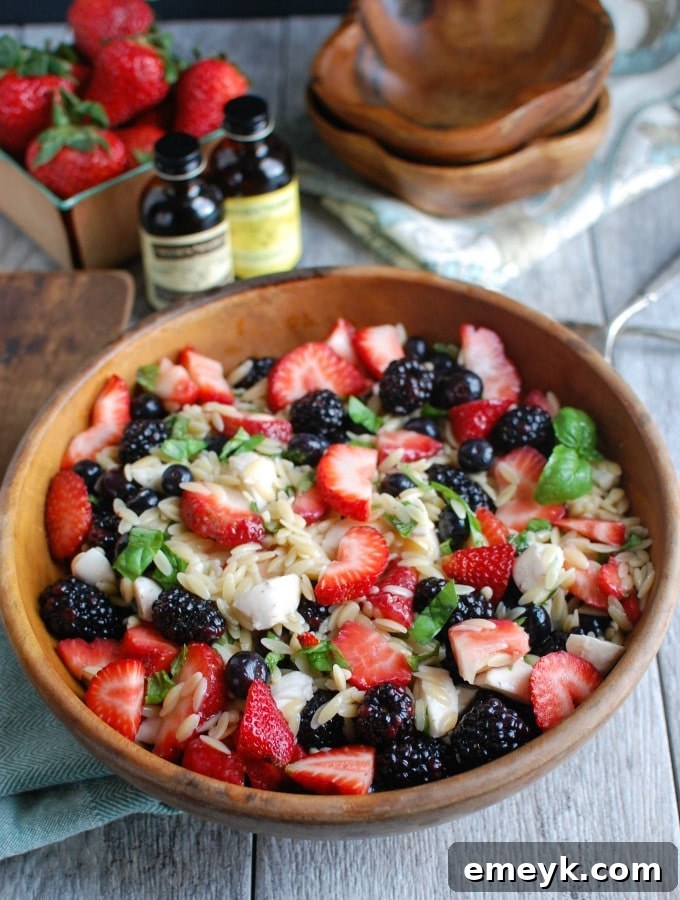 Bright and fresh Mixed Berry Caprese Orzo Salad, showcasing colorful berries and mozzarella, perfect for a summer picnic