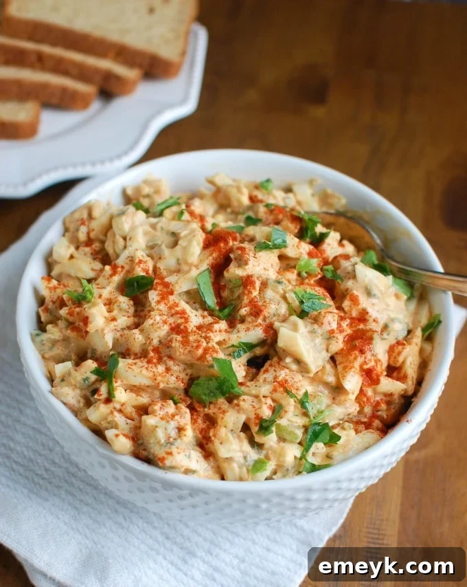 Sweet Southern-Style Egg Salad in a rustic white bowl, garnished with fresh parsley.