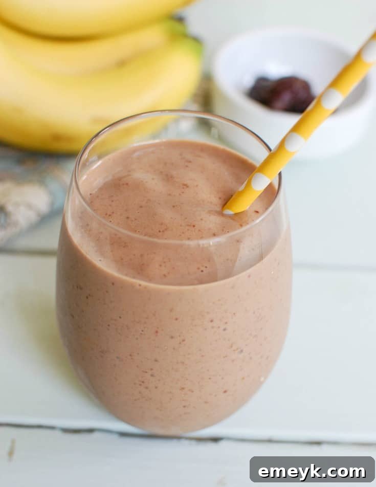 Creamy Banana Date Smoothie in a glass, looking rich and inviting. A perfect healthy treat.
