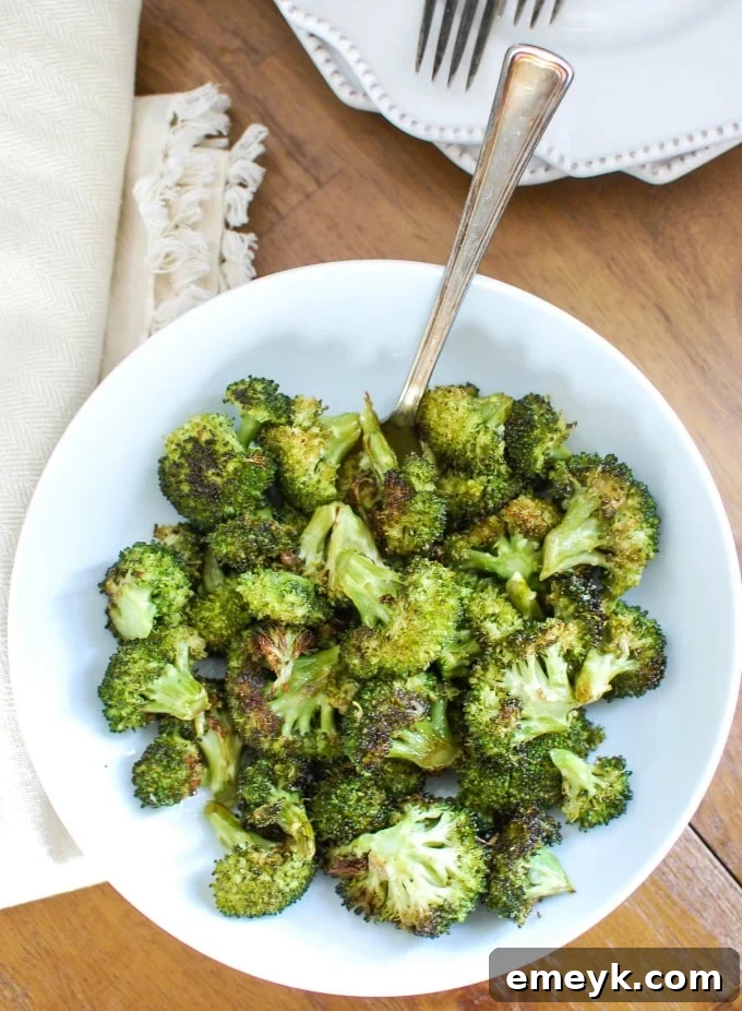 A close-up of crispy roasted broccoli in a bowl, showing the beautiful char and tender texture.