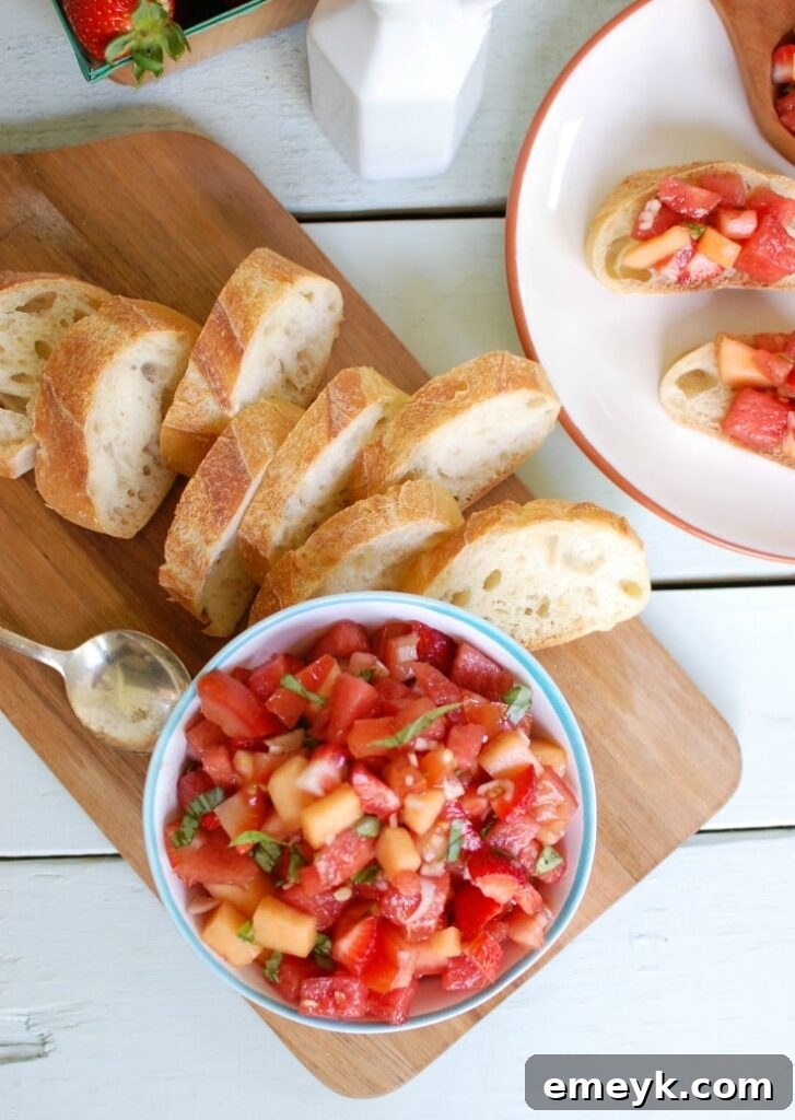 Berry Melon Bruschetta served on a platter with toasted bread slices, ready to be enjoyed as a refreshing summer appetizer.