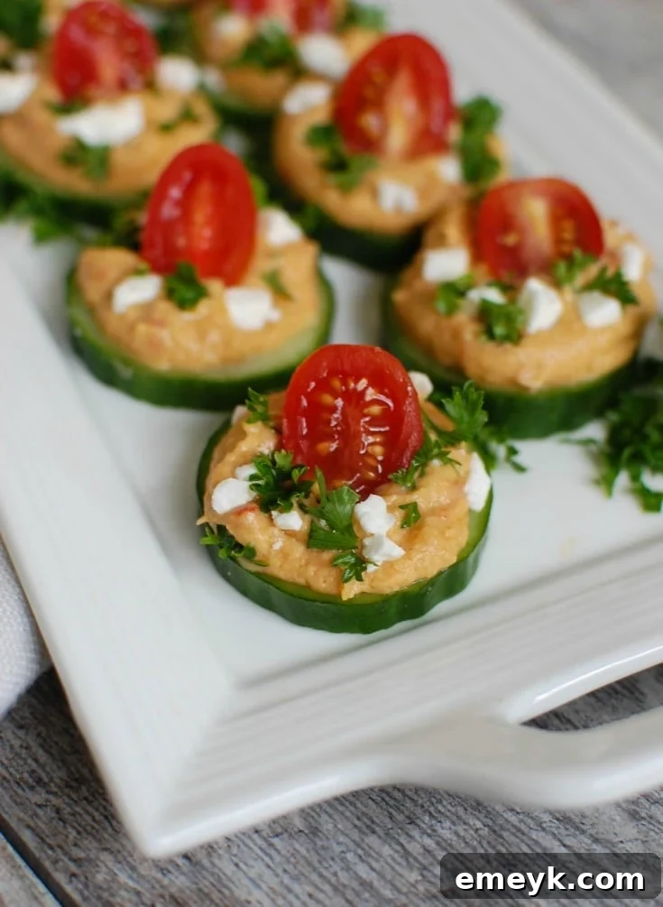 Crisp Cucumber Hummus Medallions 5 A serving of Cucumber Hummus Bites on a white plate, showcasing their inviting presentation.
