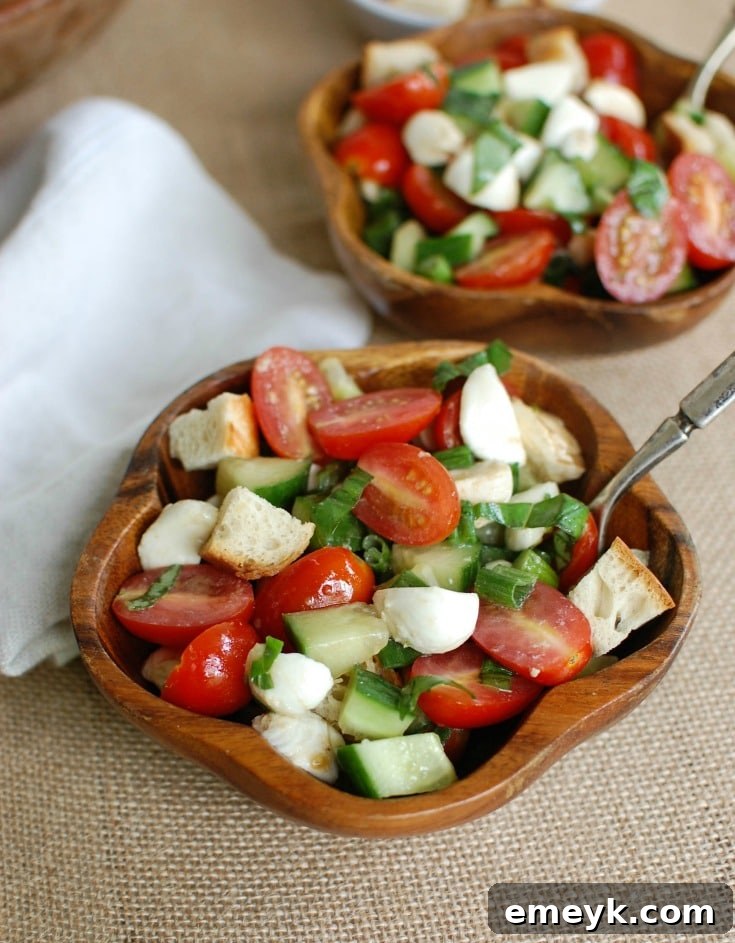 Overhead view of Caprese Panzanella with golden toasted bread cubes and vibrant ingredients, ready to be mixed.