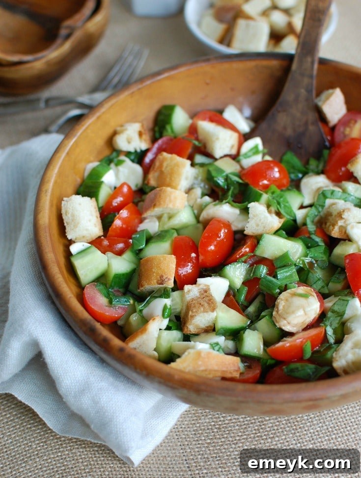 A bowl of delicious Caprese Panzanella salad, perfectly mixed and ready to be served at a summer gathering.