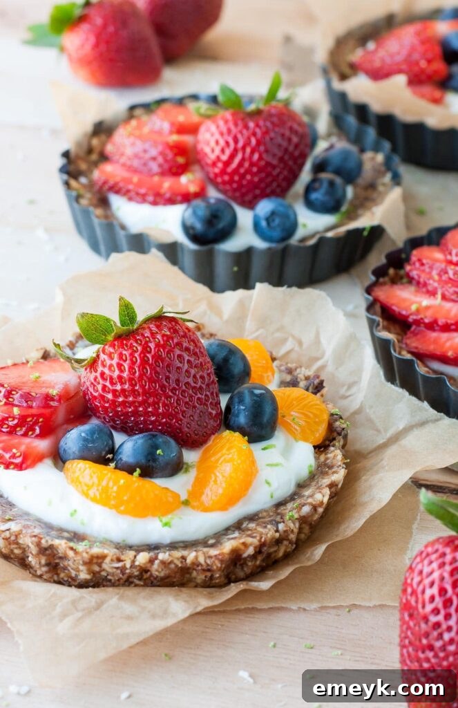 easy-no-bake-coconut-lime-fruit-yogurt-tarts-recipe-PEASandCRAYONS-3441, a refreshing and colorful treat.