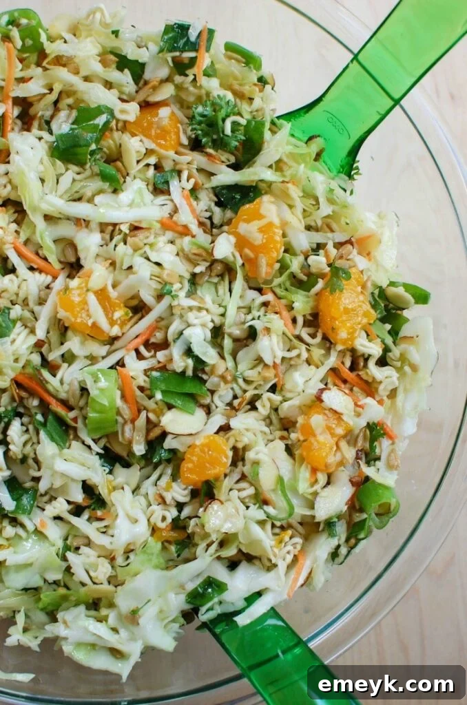 A vibrant bowl of Asian Ramen Noodle Salad, perfect for summer BBQs, featuring crunchy noodles and fresh ingredients.