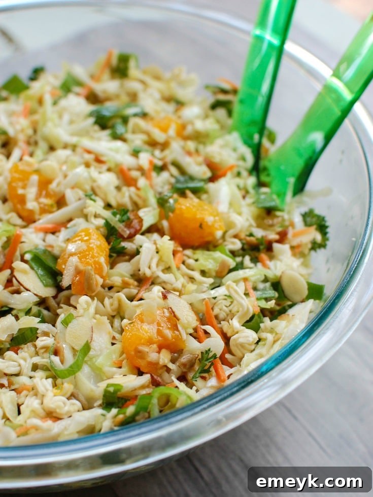 Close-up of fresh ingredients for Asian Ramen Noodle Salad, including crisp coleslaw, ramen noodles, and green onions.