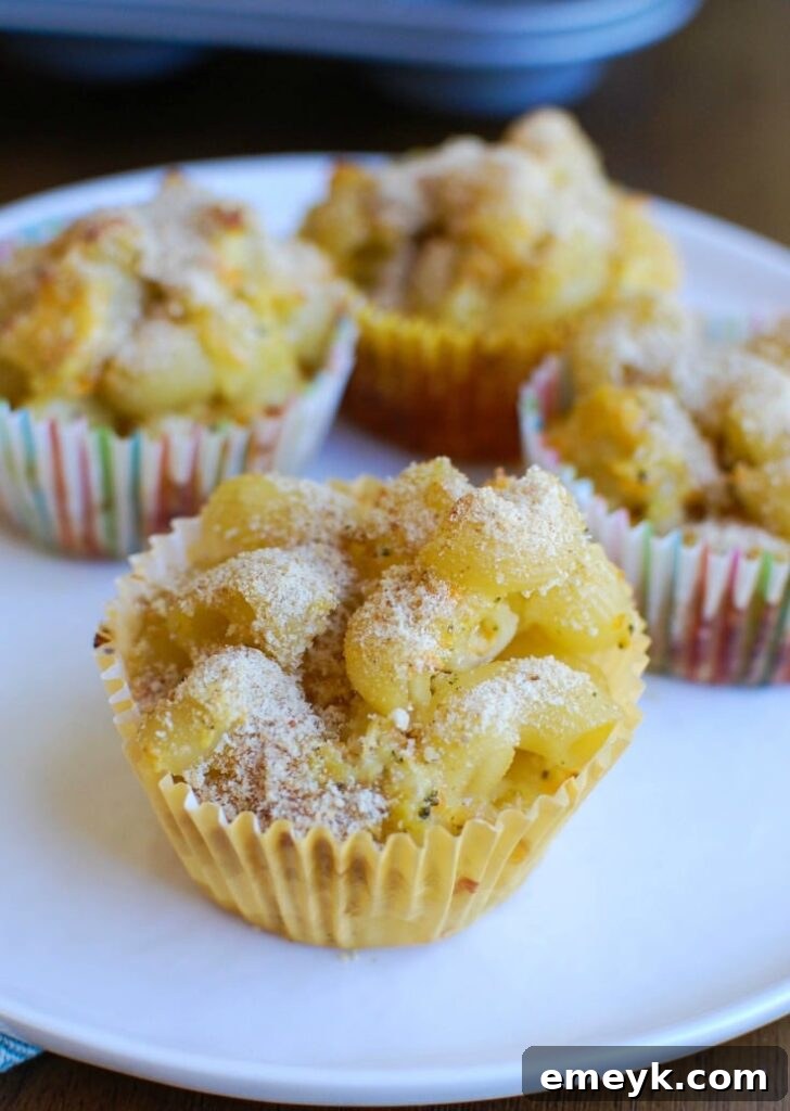 Freshly baked Mac and Cheese Muffins cooling in a muffin tin