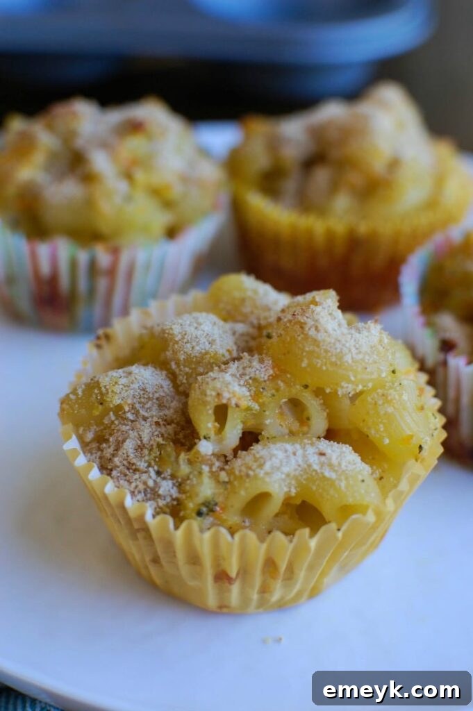 A stack of Mac and Cheese Muffins on a white plate, ready to be enjoyed